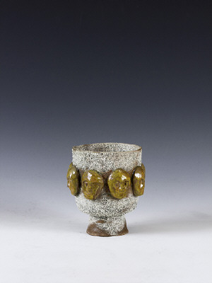 Artist: Beatrice Wood, Title: Lava Glazed Footed Bowl with Ring of Gold Masks, c. 1994 - click for larger image